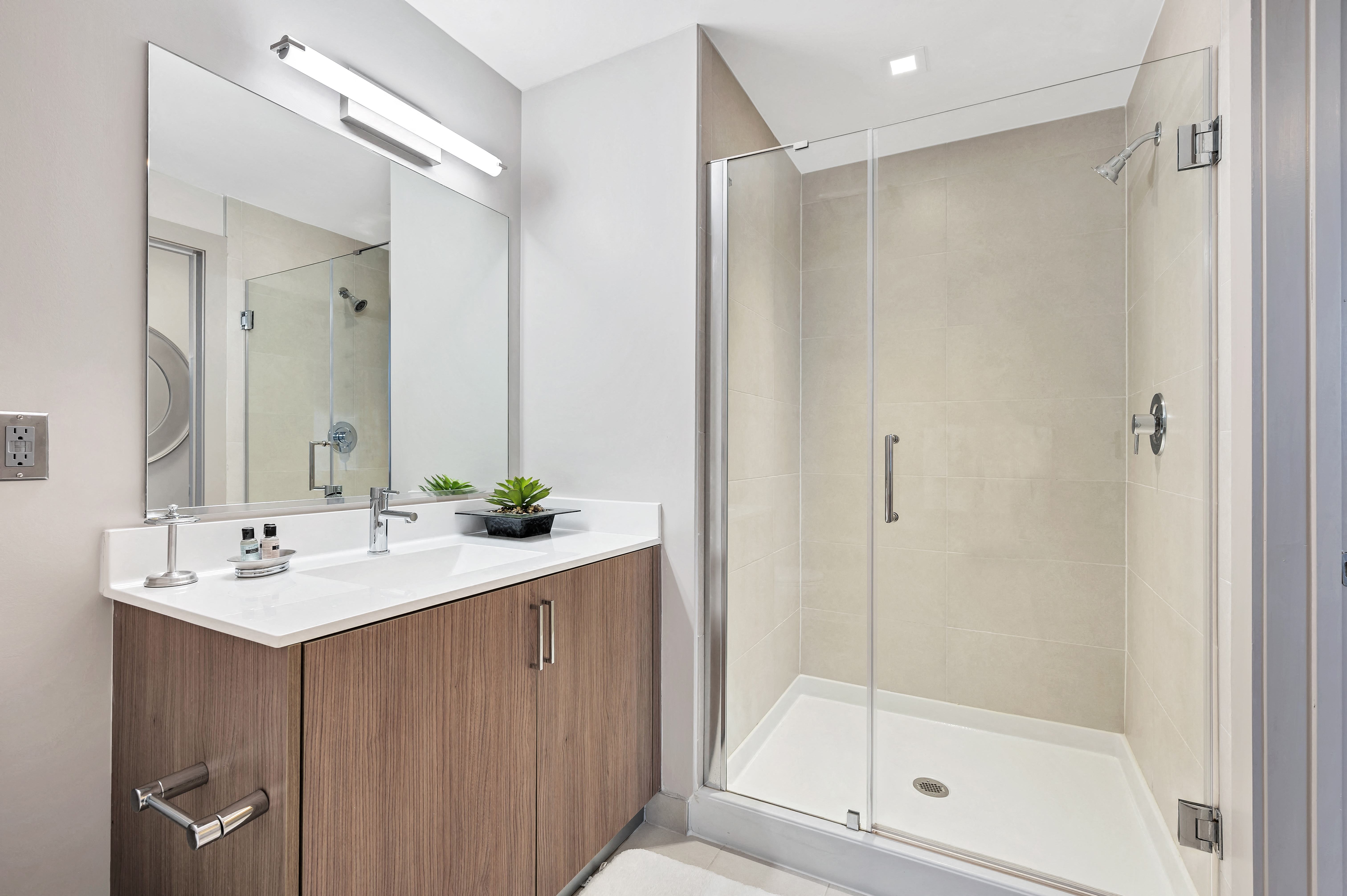 Quartz countertops and Italian style vanity in bathrooms with glass shower in select apartment homes Quartz countertops and Italian style vanity in bathrooms with glass shower in select apartment homes